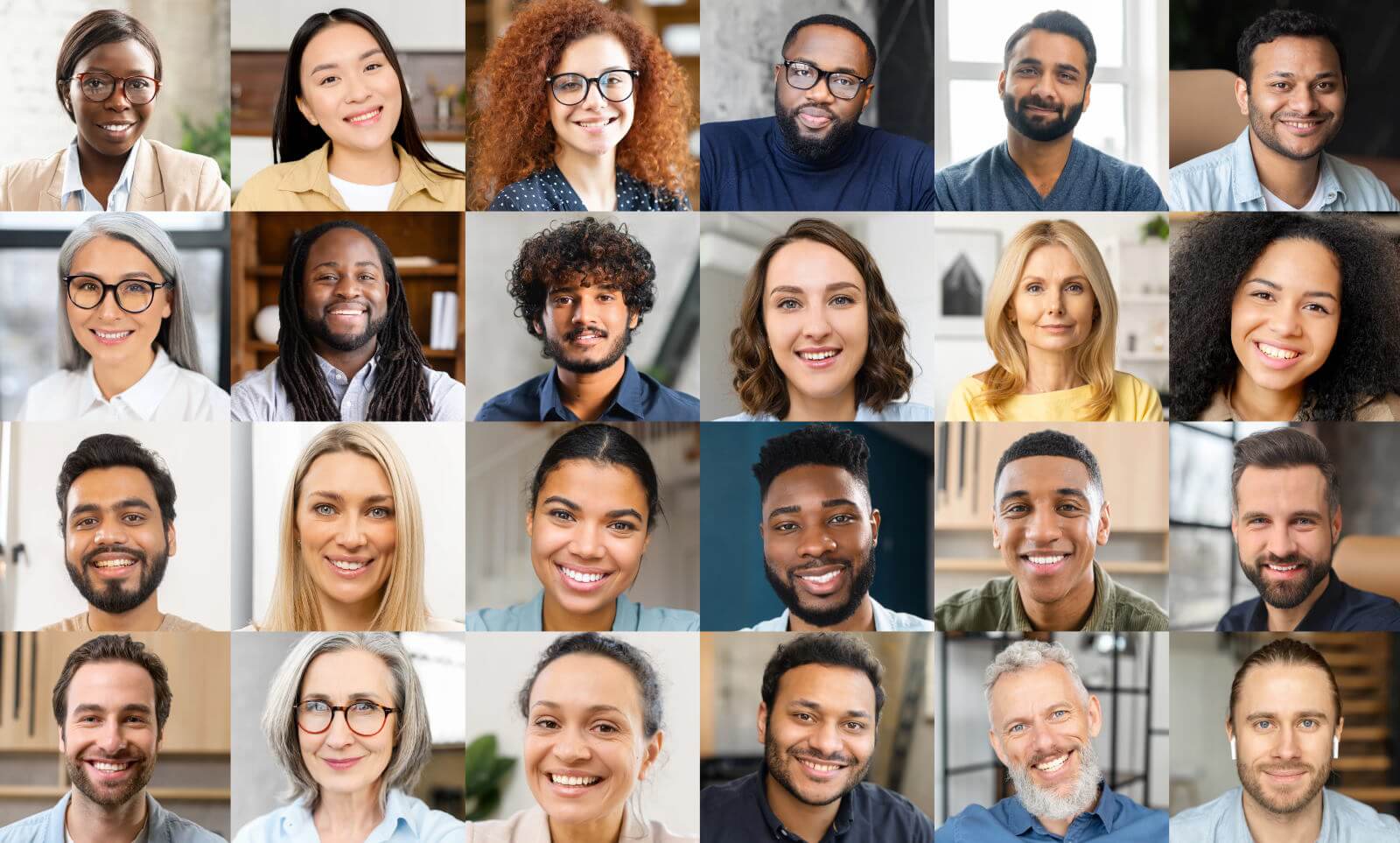 A group of people of different ages and ethnicities smiling and engaging with each other in a community meeting or social gathering.