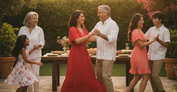 A multigenerational Hispanic family dancing together at a backyard gathering in warm evening light.
